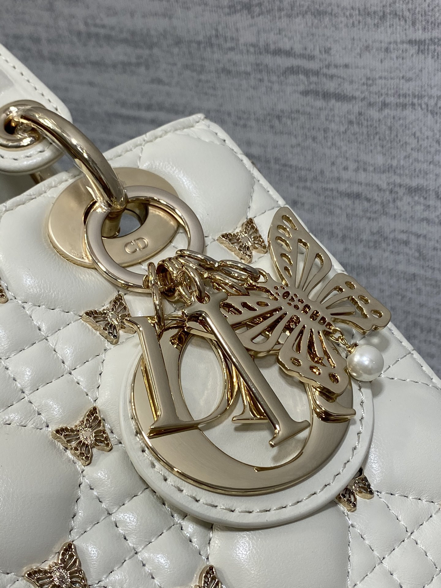 small lady D*or white with butterfly studs