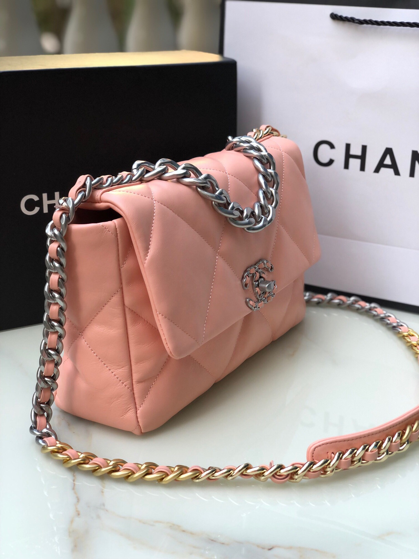 Ch*el 19 large handbag shiny leather, gold-tone, silver-tone & ruthenium-finish metal light pink 7.8 × 11.7 × 3.9 in